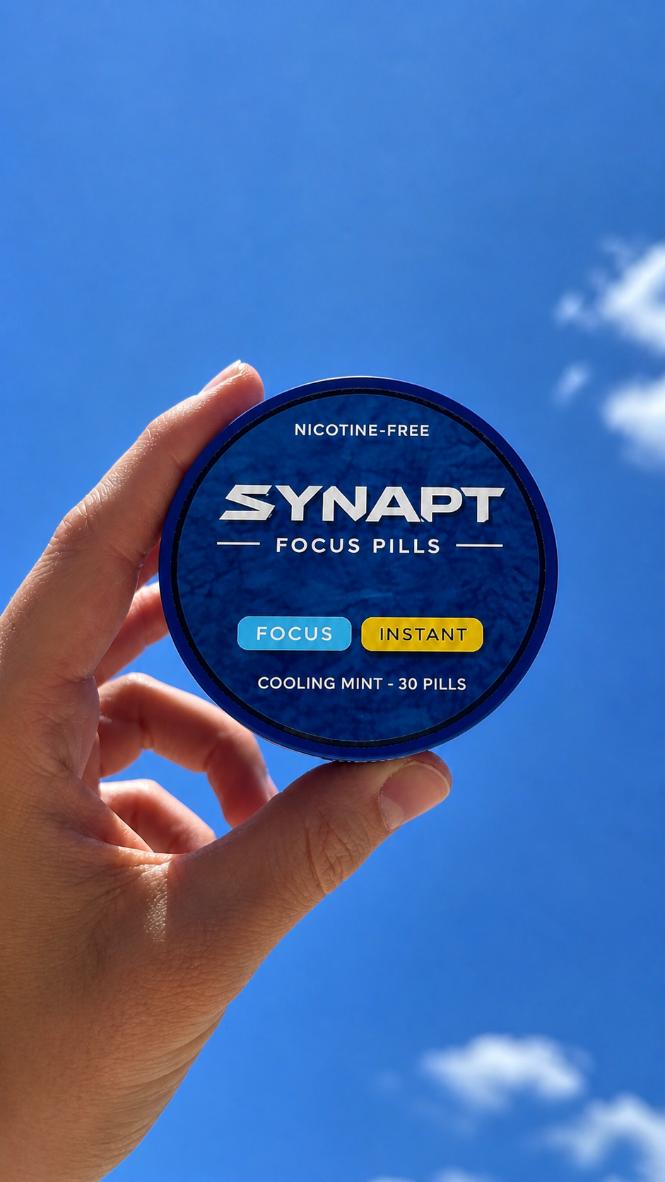 Synapt Focus Pills tin held up against a blue sky.